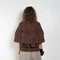 The Ruffle Tiered Top by Meryll Rogge is a crisp cotton top with layered ruffles that can be tucked into your trousers