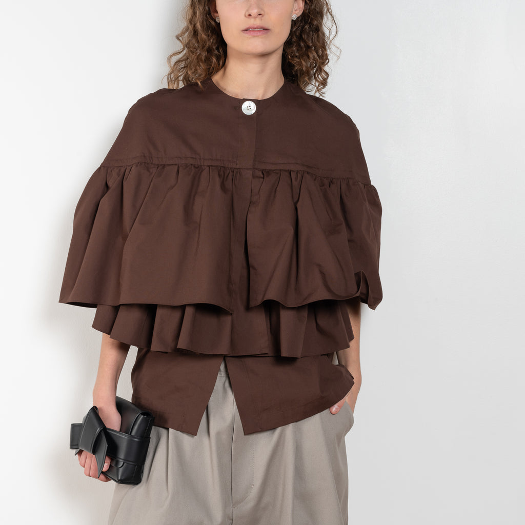 The Ruffle Tiered Top by Meryll Rogge is a crisp cotton top with layered ruffles that can be tucked into your trousers