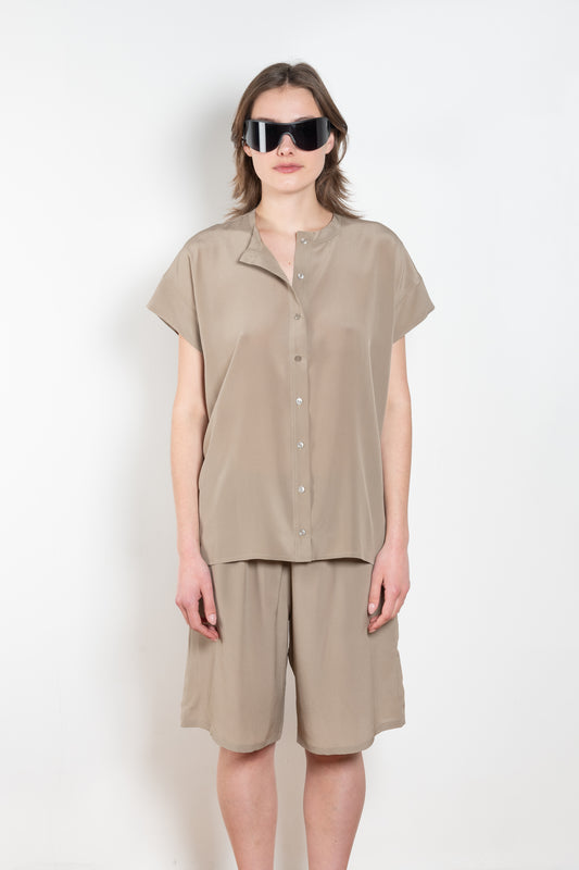 The Lily Top by Monique Van Heist is a short sleeved silk top with a buttoned mao collar