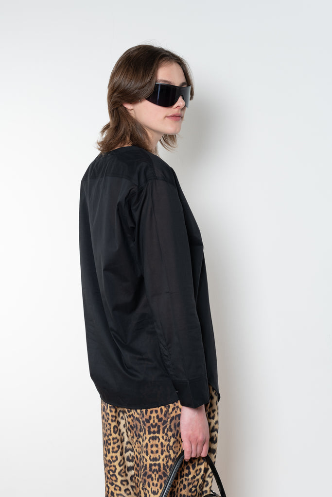 The V Shirt by Monique Van Heist is a loose fitted shirt with baseball inspired details