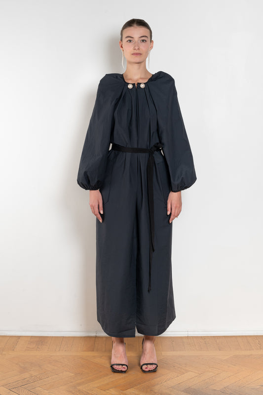 The Grand Bazaar Dress by Nackiye is a signature dress with shawl shoulder feature, two pockets, front slit and a belt, and the classic double pearl neck pin 