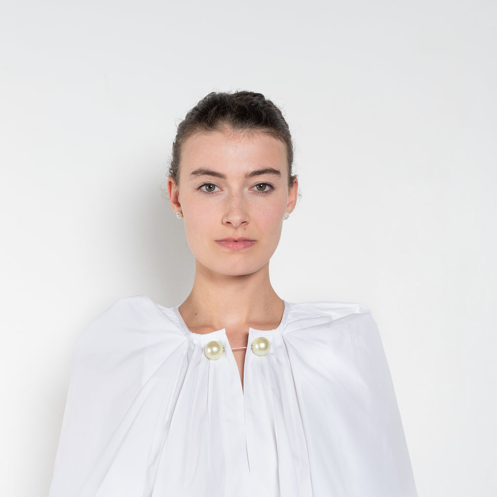 The Grand Bazaar Mini Top by Nackiye is a signature top with shawl shoulder feature and the classic double pearl neck pin in a mini version