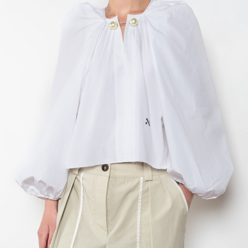 The Grand Bazaar Mini Top by Nackiye is a signature top with shawl shoulder feature and the classic double pearl neck pin in a mini version