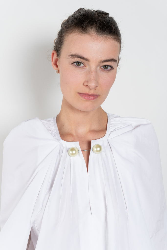 The Grand Bazaar Mini Top by Nackiye is a signature top with shawl shoulder feature and the classic double pearl neck pin in a mini version