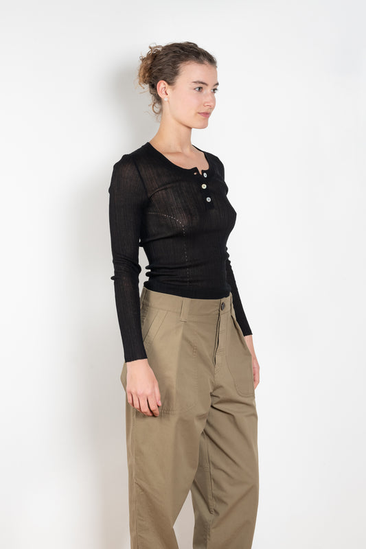 The Keep Close Top is a tightly ribbed buttoned Henley crew neck