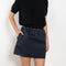 The Mini Skirt by Nackiye is gathered at the waist and featuring two side pockets, the little mini also has raw edging embellished with a rubber like piping