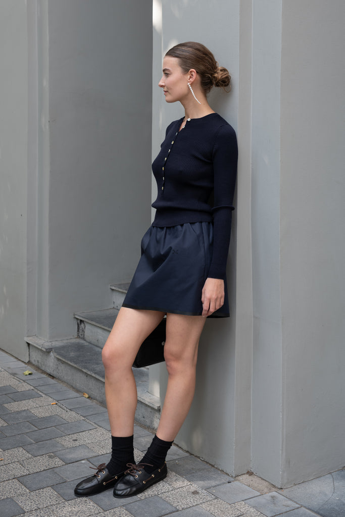 The Mini Skirt by Nackiye is gathered at the waist and featuring two side pockets, the little mini also has raw edging embellished with a rubber like piping