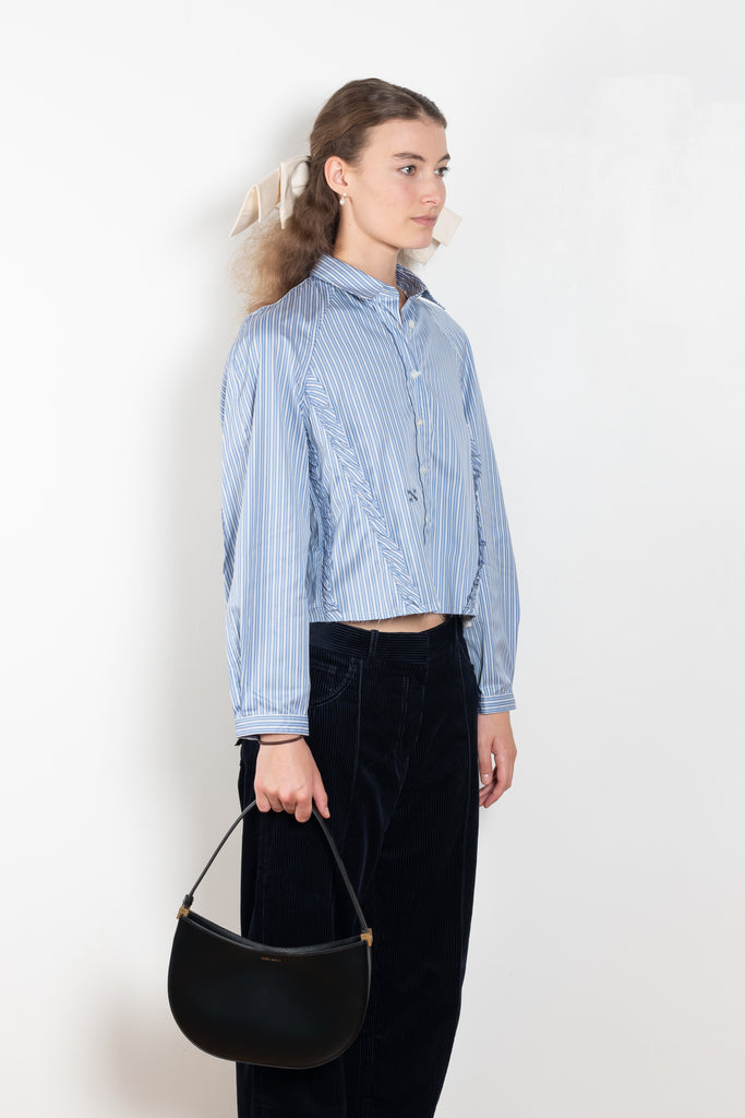 The Moshi Moshi Top by Nackiye is a buttoned up tailored shirt with front and back ruffles