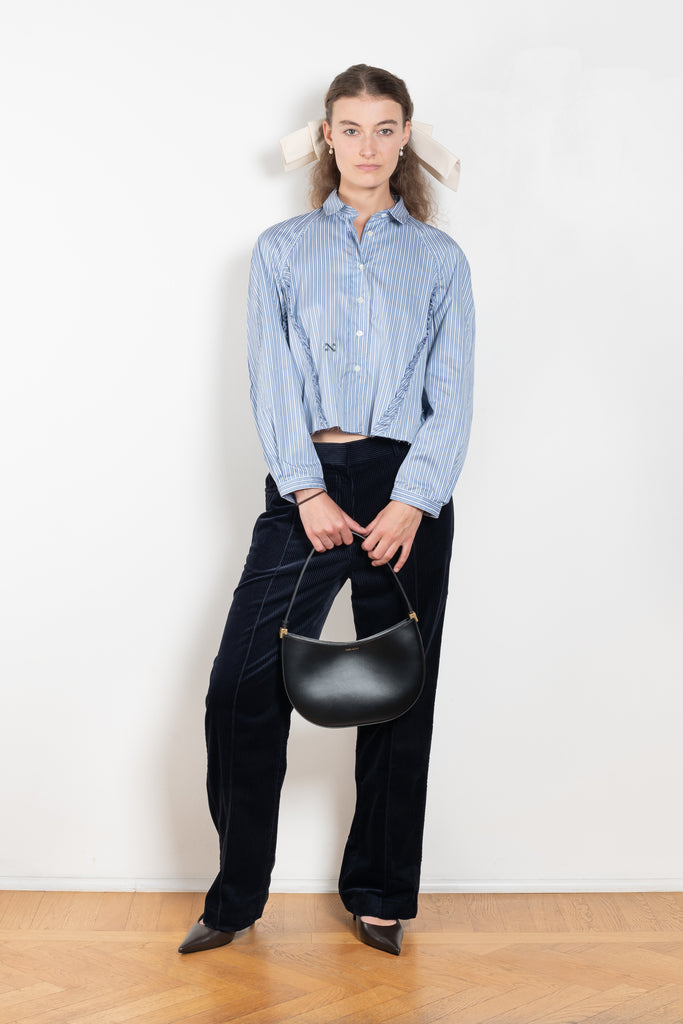 The Moshi Moshi Top by Nackiye is a buttoned up tailored shirt with front and back ruffles