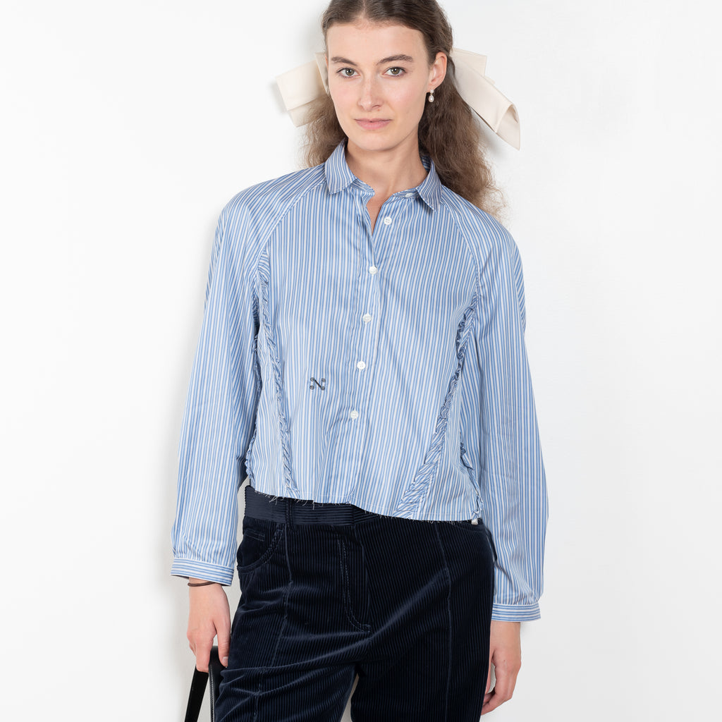 The Moshi Moshi Top by Nackiye is a buttoned up tailored shirt with front and back ruffles