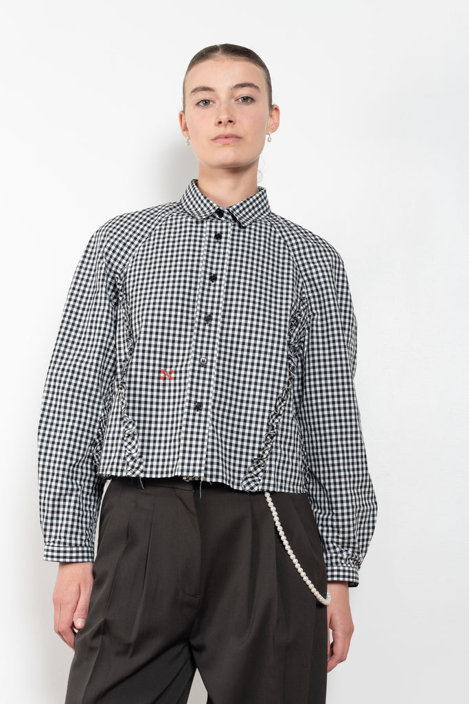 The Moshi Moshi Top by Nackiye is a buttoned up tailored shirt with front and back ruffles