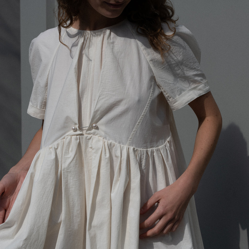 The Peony Dress by Nackiye is a sweet short babydoll inspired dress with a detachable collar detail and an pearl pin embellishment