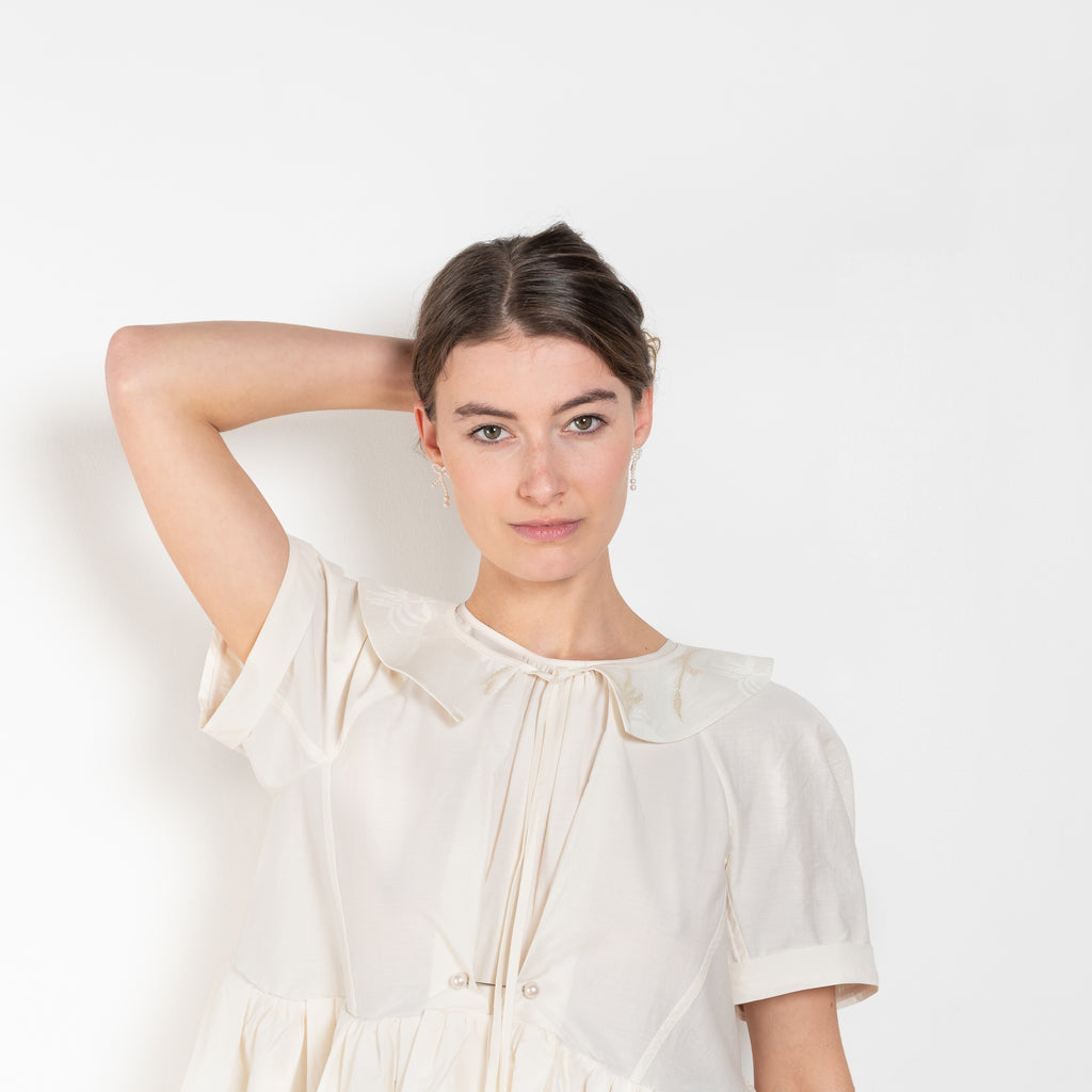 The Peony Dress by Nackiye is a sweet short babydoll inspired dress with a detachable collar detail and an pearl pin embellishment