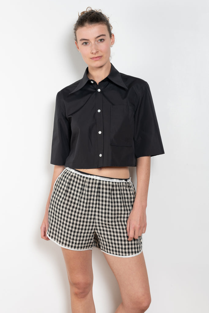 The Shortcut Shirt by Nackiye is a crop shirt with pointy collar and faux front pockets