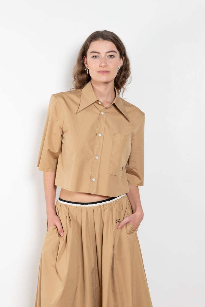 The Shortcut Shirt by Nackiye is a crop shirt with pointy collar and faux front pockets. 