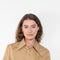 The Shortcut Shirt by Nackiye is a crop shirt with pointy collar and faux front pockets. 