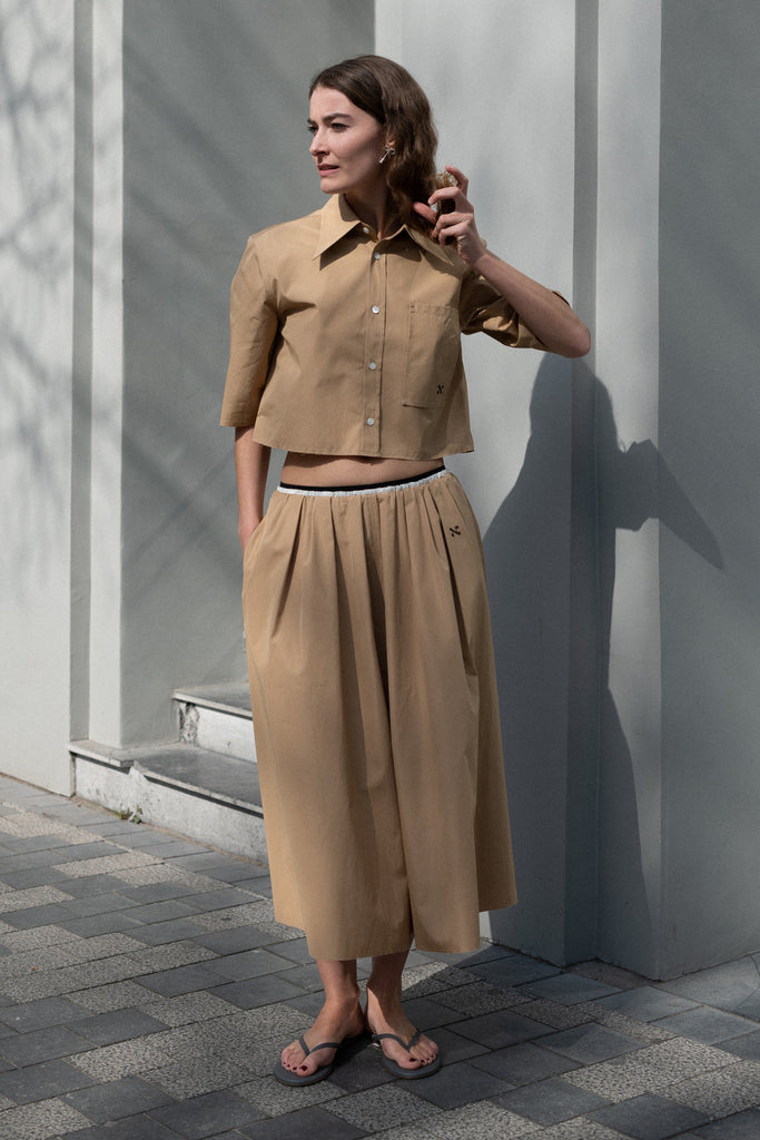 The Shortcut Shirt by Nackiye is a crop shirt with pointy collar and faux front pockets. 