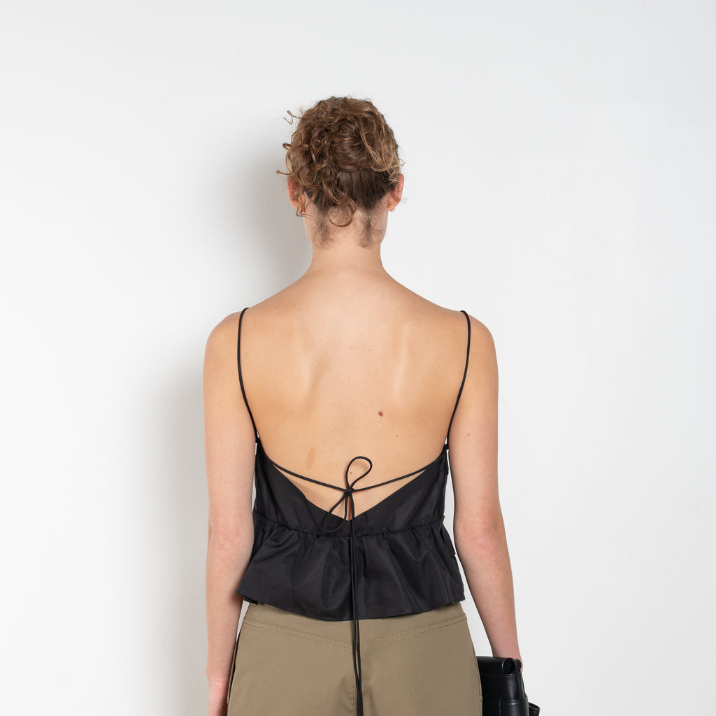 The Surf Rider Top by Nackiye is a delicate strappy top in cotton with a ruffle hem