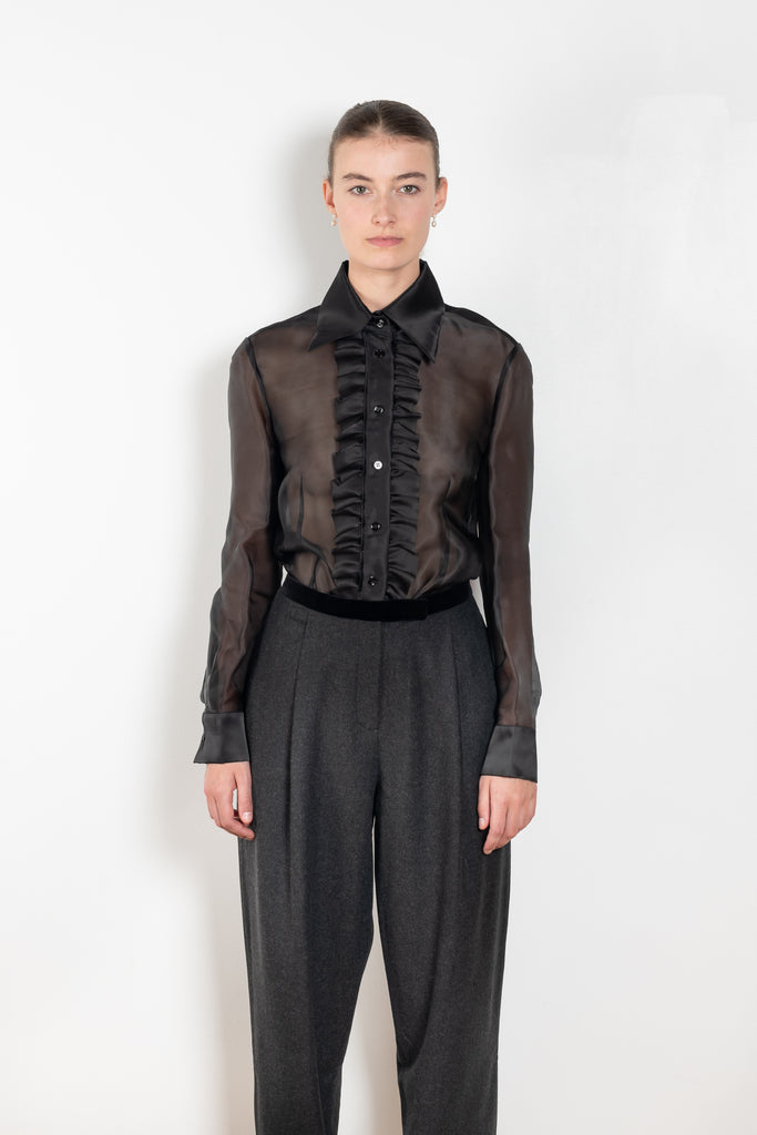 The White Rabbit Top by Nackiye is a silk see-trough shirt with a front ruffle plaquette