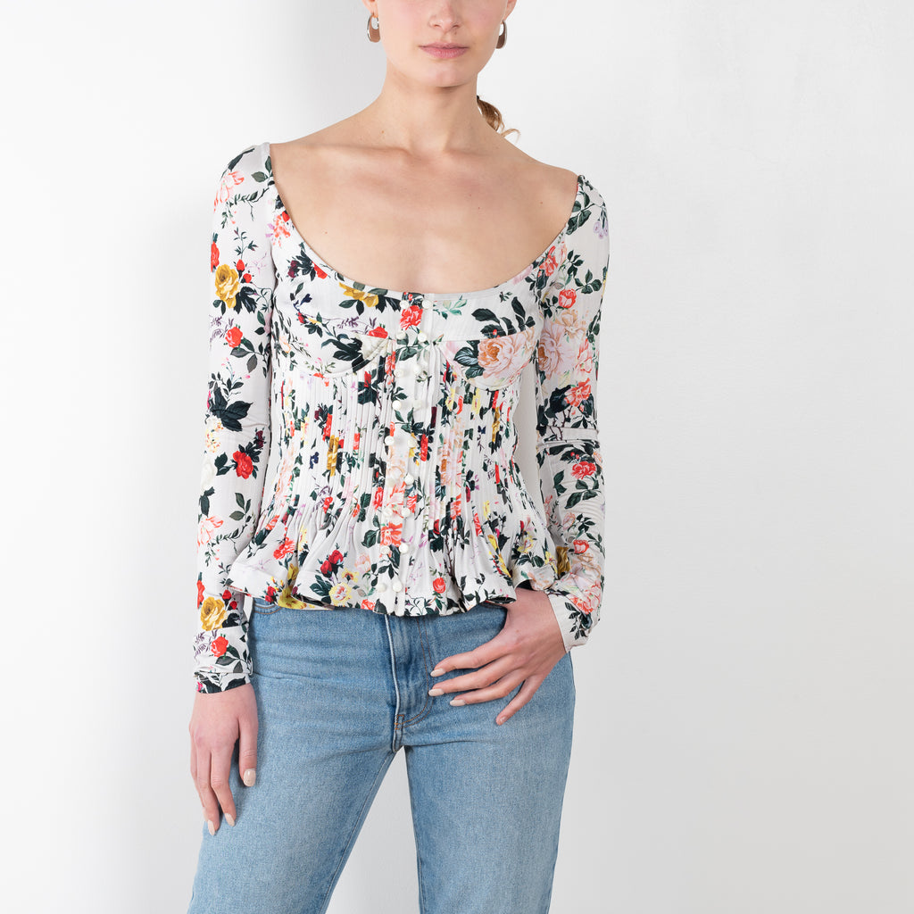 The Floral Peplum Top by Paco Rabanne is a floral top with a bustier upper and peplum details