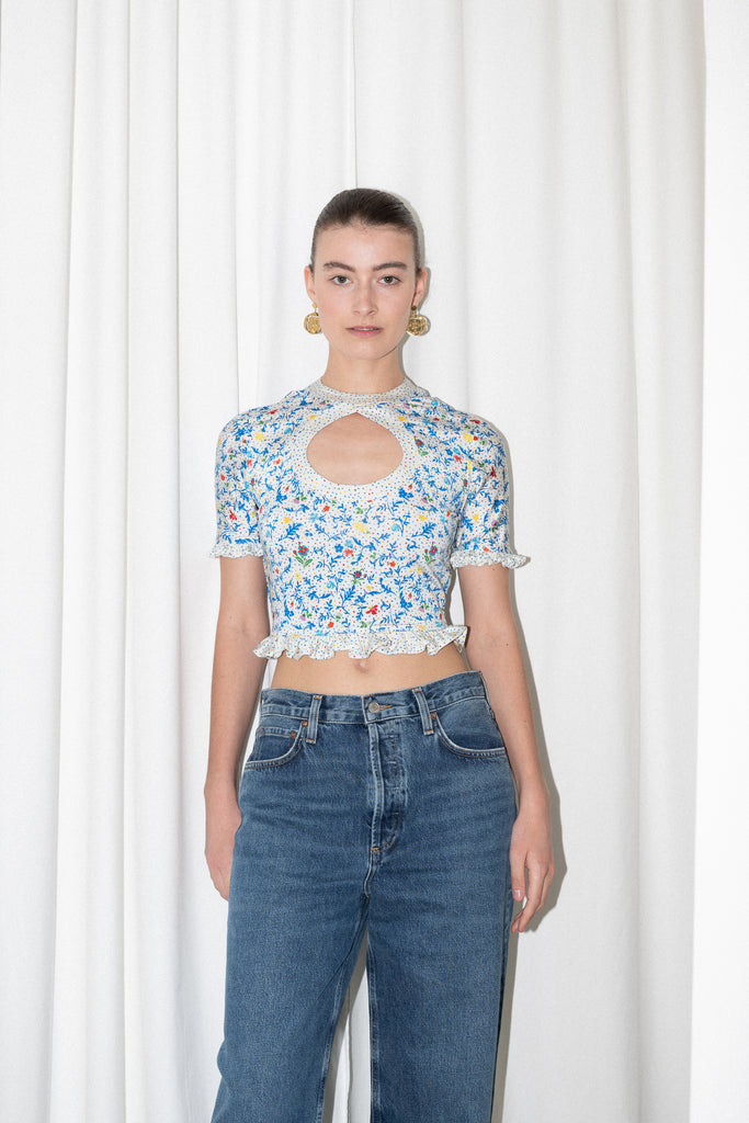 The Floral Cut-out Top by Paco Rabanne is a cropped top in jersey with a front and back cut-out