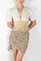 The Leopard Skirt by Paco Rabanne is a mini skirt with adjustable press buttons in a leopard print