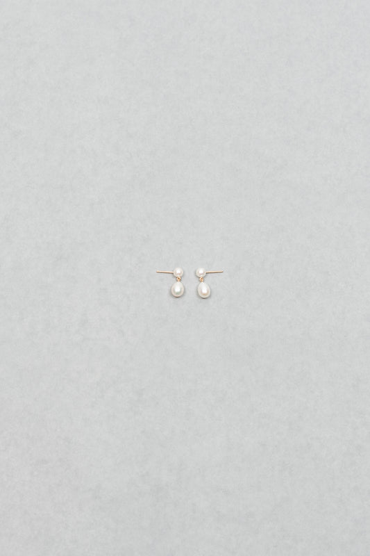 The Venus D'Eau Earrings by Sophie Bille Brahe is a petite pair of pearl earrings featuring a delicate drop shaped pearl dangling from the ear