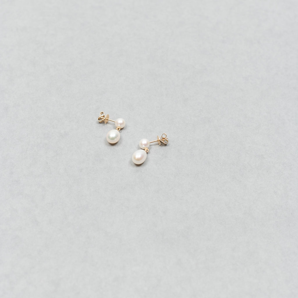 The Venus D'Eau Earrings by Sophie Bille Brahe is a petite pair of pearl earrings featuring a delicate drop shaped pearl dangling from the ear