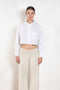 The  Leuka Cropped Shirt by Suzie Kondi has a cropped boxy fit, cuffed wrists for a crisp look.