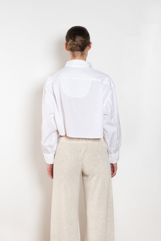 The  Leuka Cropped Shirt by Suzie Kondi has a cropped boxy fit, cuffed wrists for a crisp look.