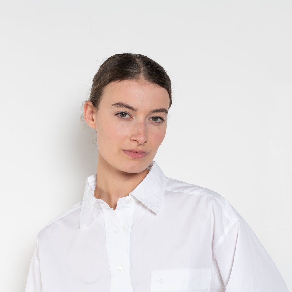 The  Leuka Cropped Shirt by Suzie Kondi has a cropped boxy fit, cuffed wrists for a crisp look.