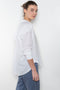 The Jordy Shirt by Xirena is&nbsp;an easy button-front shirt with a boxy fit, left chest pocket, and high low shirttail hem