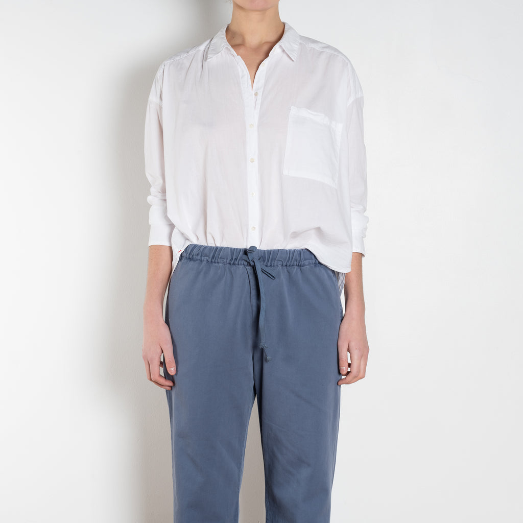 The Jordy Shirt by Xirena is&nbsp;an easy button-front shirt with a boxy fit, left chest pocket, and high low shirttail hem