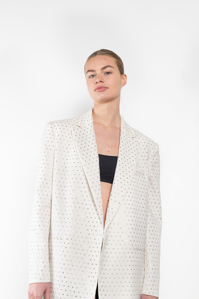 The Guia Blazer by The Andamane is a relaxed oversized blazer with all-over crystals in a bright white