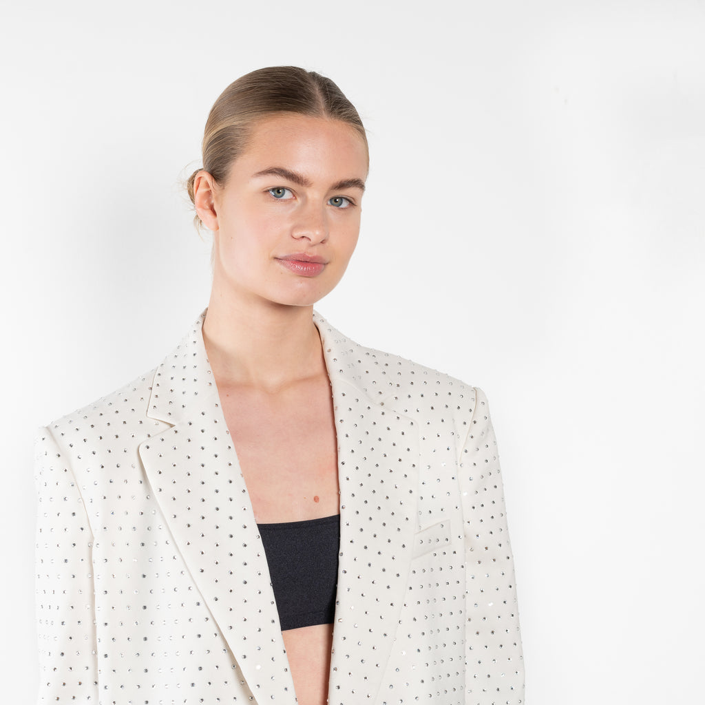 The Guia Blazer by The Andamane is a relaxed oversized blazer with all-over crystals in a bright white