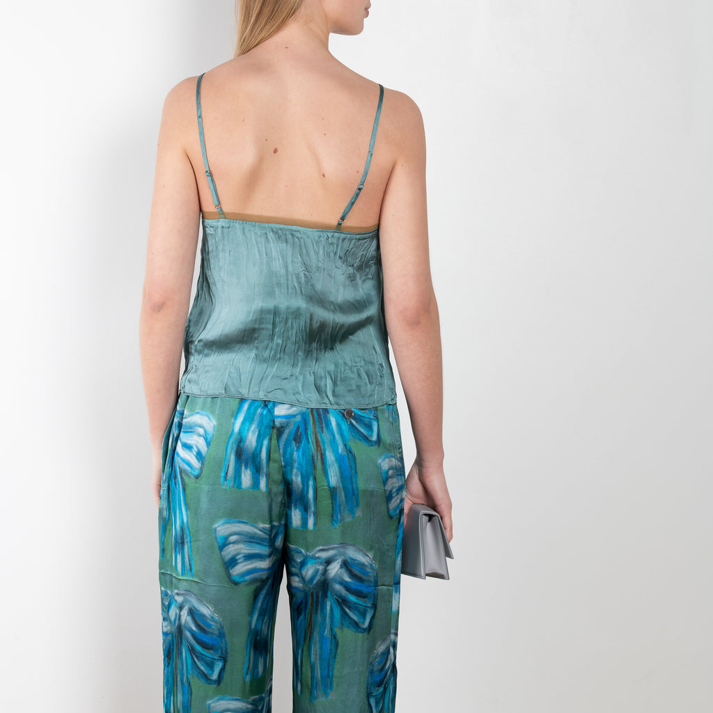 The Bow Print Trouser 1011 by Acne Studios is a crinkled trouser in a bow print by artist Karen Kilimnik with a loose volume on the leg