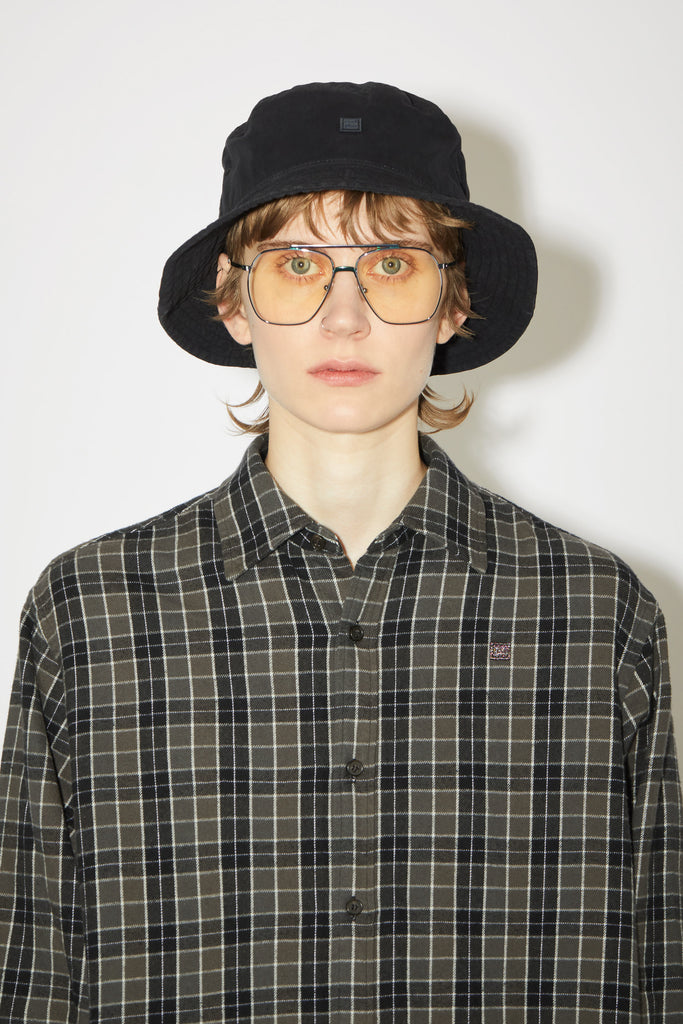 The Cotton Bucket Hat 107 by Acne Studios is a black bucket hat made out of peachy hand feel cotton with faded effect fabric