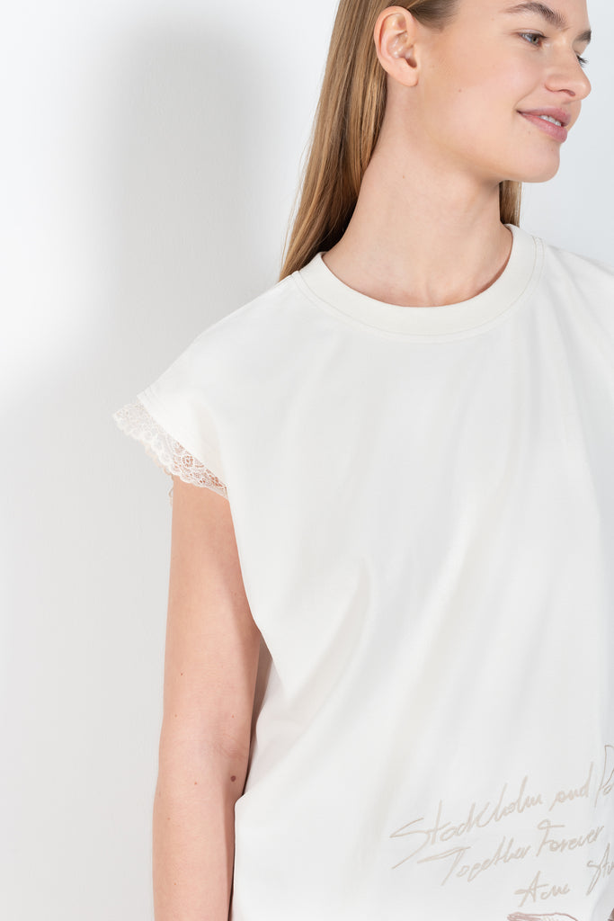 The Embroidered Dress 885 by Acne Studios is a short sleeved dress with a branded embroidery in this season's wedding theme, with contrast lace trims 