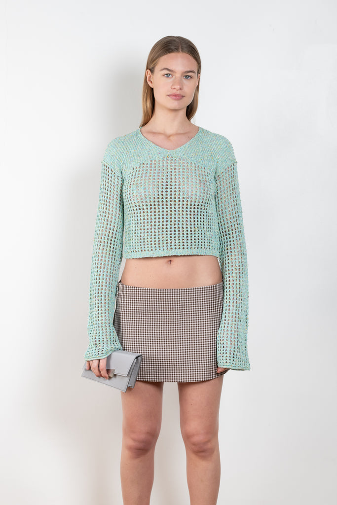 The Knitted Jumper 546 by ACNE STUDIOS is a aqua blue jumper in a knitted tonal yarn with a crochet knit finish and a semi-sheer appearance