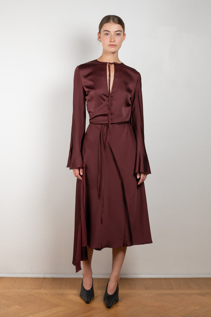 The Satin Dress 776 by ACNE STUDIOS has flared long sleeves, a side slit and asymmetric hem and closes with wrap tie ribbons at the waist