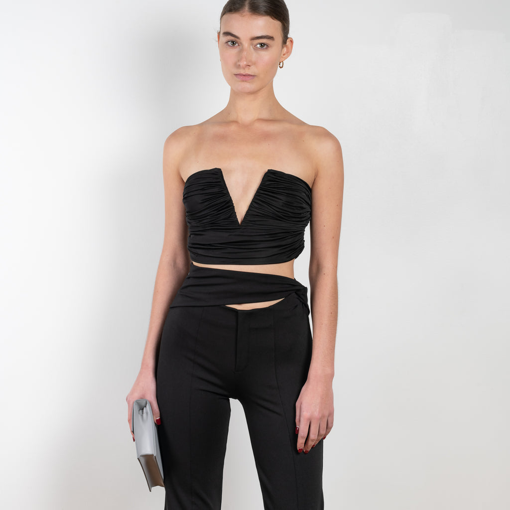 The Sesis Top by GAUGE81 is a minimal bustier top with ruching creating waves and a bold V neck