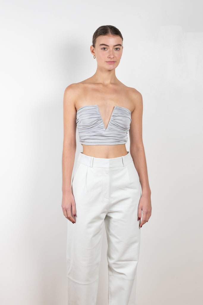 The Sesis Top by GAUGE81 is a minimal bustier top with ruching creating waves and a bold V neck