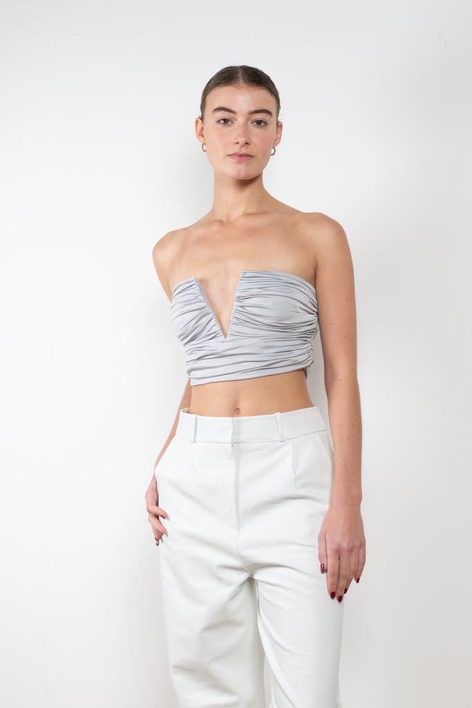 The Sesis Top by GAUGE81 is a minimal bustier top with ruching creating waves and a bold V neck