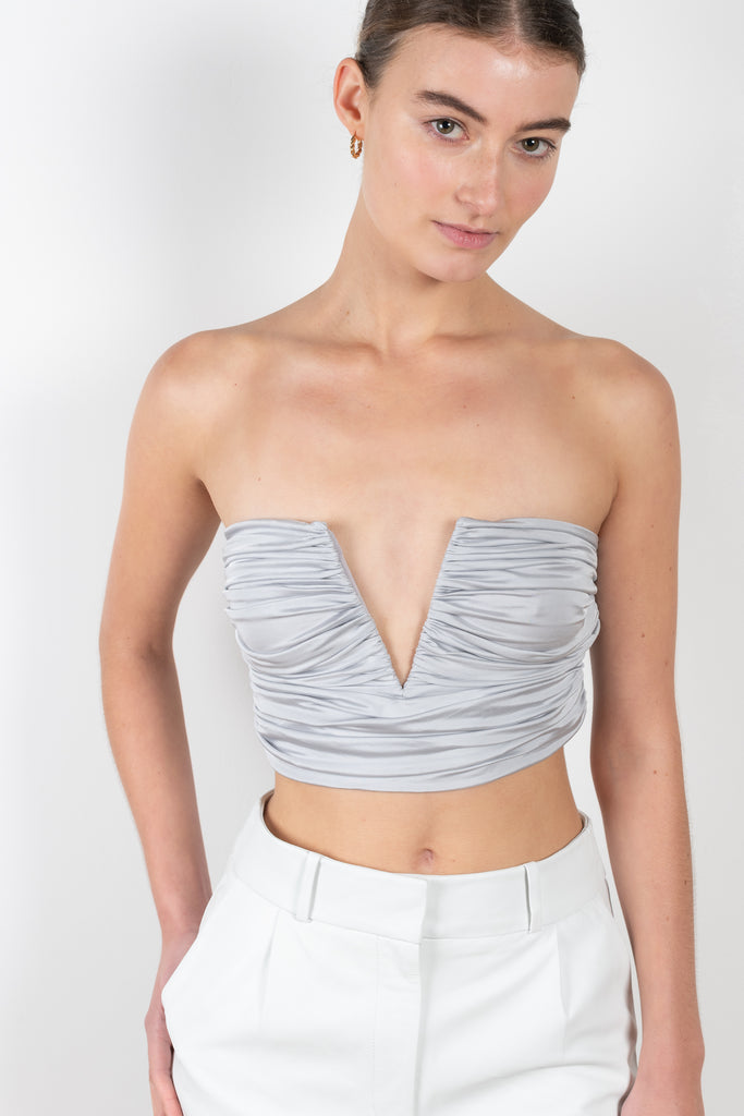 The Sesis Top by GAUGE81 is a minimal bustier top with ruching creating waves and a bold V neck