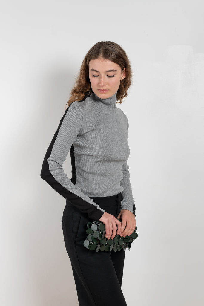 The Two Tone Top by Gauchere is a turtleneck top with a long slim fit in ribbed two tone cotton