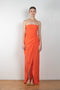 The Lica Long Dress by Gauge81 is a long silk bustier dress with front slit in a vibrant orange linen