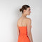 The Lica Long Dress by Gauge81 is a long silk bustier dress with front slit in a vibrant orange linen