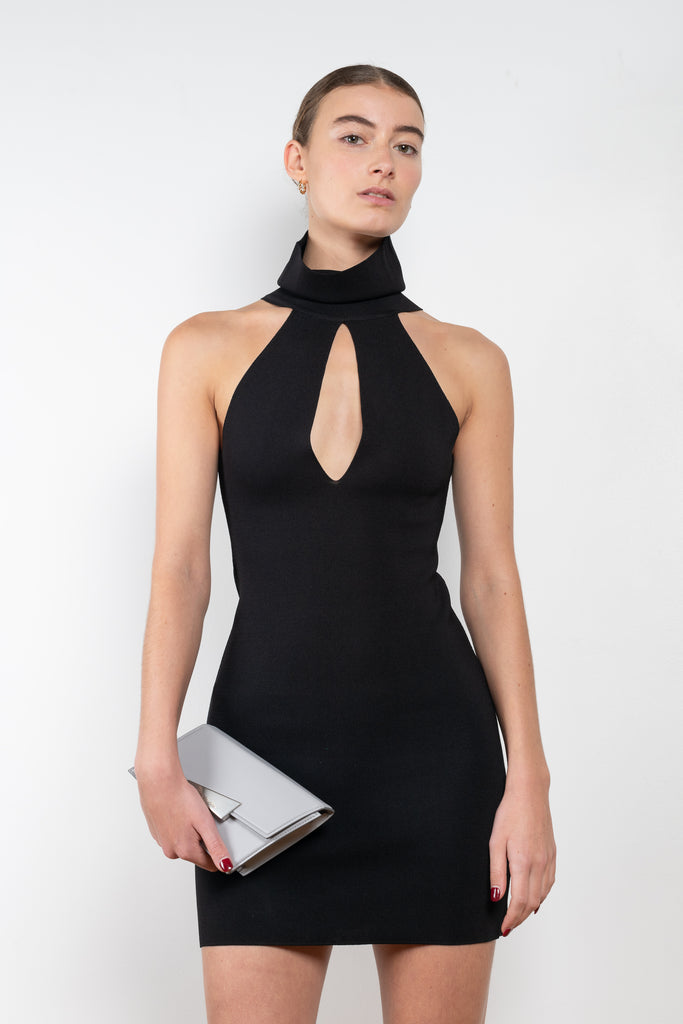 The Maioris Dress by GAUGE81 is a knitted slim cut mini dress with a halter/turtle neck and a bold front cut out