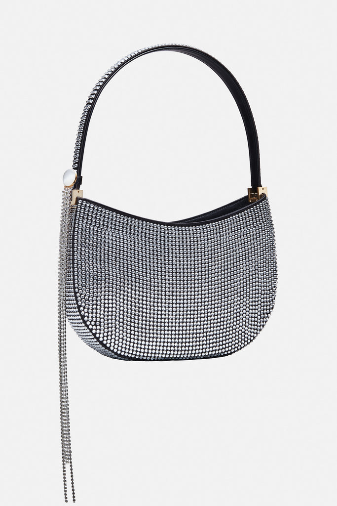 The Medium Vesna bag by Magda Butrym is a hobo bag with a classic yet trendy shape covered in crystals with a detachable signature strass brooch