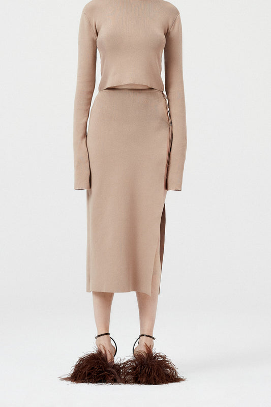 The Knit Cutout Skirt 09 by Magda Butrym is a lightweight knitwear midi skirt with an open side and cutout at the hip, with two ties as closure